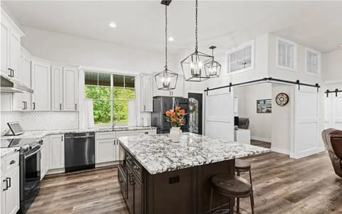 Spacious layout with bar seating makes it perfect for cooking  gathering.