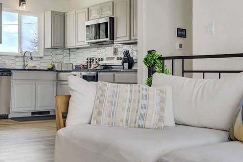 This bright living space offers a seamless flow into the kitchen and dining areas. The open layout and vaulted ceilings make it easy for the whole group to gather and socialize together.