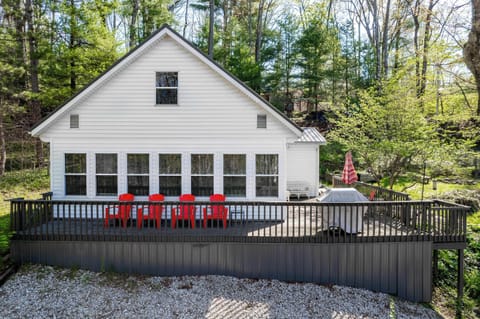 Charming cabin-style exterior w/ porch seating, perfect for slow mornings in a peaceful wooded setting