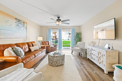 Bright & airy living room with plenty of natural light & sliding glass doors leads to ground floor patio walkout