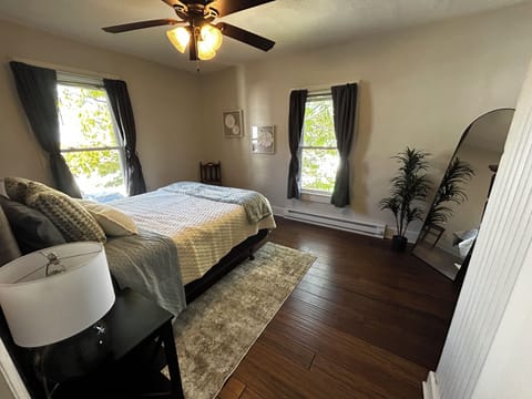 Bedroom with hardwood flooring.