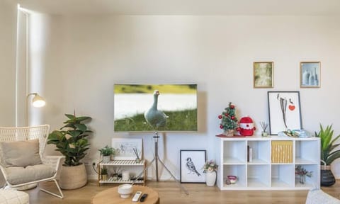 A bright and cozy living space adorned with tasteful decor, a low table, and greenery.