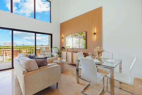 Effortless elegance meets vacation comfort. This beautifully designed living area features high ceilings, designer furnishings, and expansive glass doors leading to peaceful outdoor views.