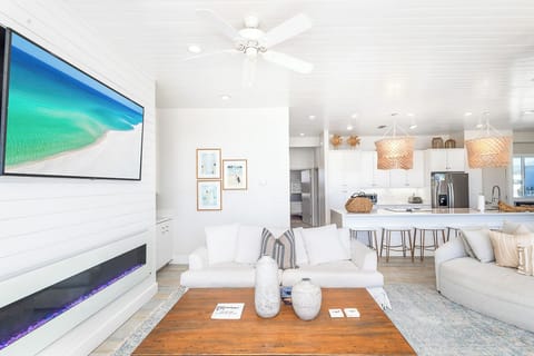 One of many generous living spaces, with amazing Gulf views and ample seating among thoughtful amenities that provide a refined, fun and welcoming home away from home..