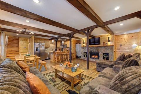 Cozy up in your rustic mountain retreat with crackling fireplace and plush seating perfect for relaxing after adventure-filled days.