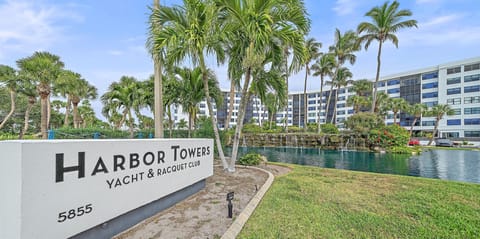 Harbor Towers Yacht & Racquet Club entrance sign at 5855, marking the gateway to this waterfront resort community.