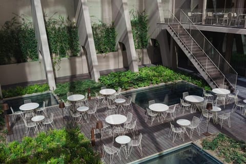 Escape into a lush courtyard oasis beside tranquil reflecting pools.