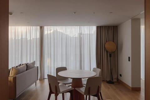 Gather for meals by floor-to-ceiling windows and soft light.
