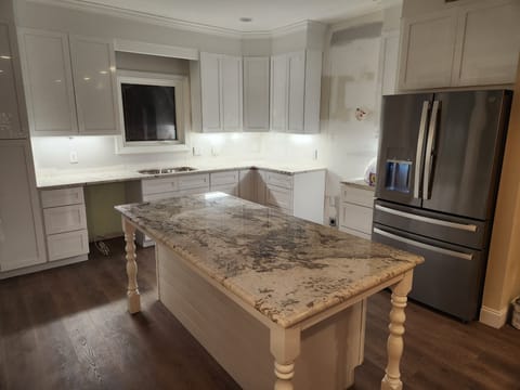 Your gourmet kitchen awaits with elegant granite countertops, stainless steel appliances, and a spacious island perfect for preparing memorable meals together.