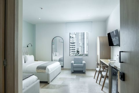 Bright living area with sofa and workspace.