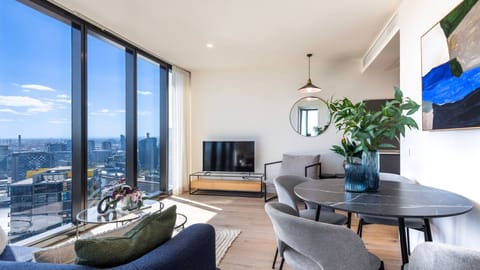 Bright living area with floor to ceiling windows and city views