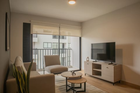 Bright living room with large windows and access to a cozy balcony.