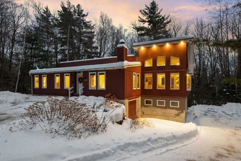 A warm and inviting home in the forest, perfect for relaxing winter escapes
