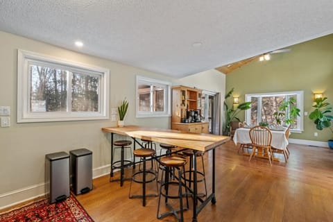Bright open kitchen with a long bar table - perfect for shared meals with friends and family!