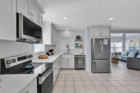 Fully equipped kitchen with fridge, oven, stove, microwave, toaster, coffee maker, basic cooking utensils, dishware, and more!