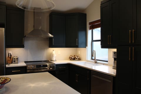 Kitchen - The kitchen includes oak cabinetry, granite countertops and a spacious island counter.
Outfitted with stainless steel appliances, including a full-size refrigerator, oven, microwave, and dishwasher.