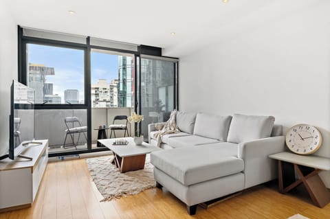 Bright living area with comfortable seating and floor-to-ceiling windows