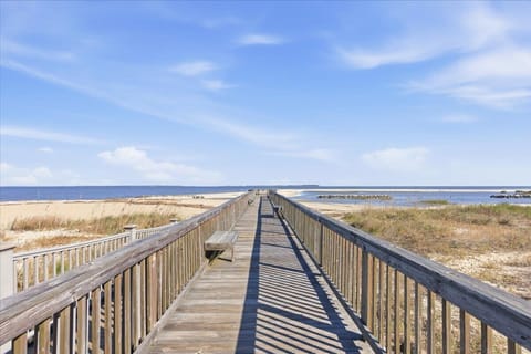 Steps from the shore with a private boardwalk, scenic pier, and relaxing beachside swings.