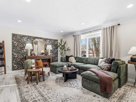 Spacious living room w/ plush seating, layered rugs & sunlight streaming in—made for slow mornings and cozy nights 🛋️☀️✨