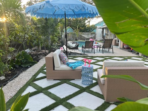 Relax poolside surrounded by lush tropical greenery.