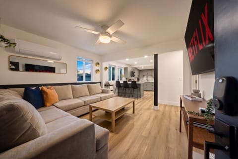 Bright modern living room with smart TV – perfect for relaxing stays