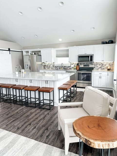 Huge open kitchen is stocked with everything you'll need for your stay from dishes, bakeware, cookware, and more.