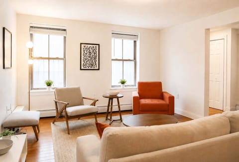 Bright, comfortable living area with plenty of natural light, cozy seating, and space to unwind after a day in the city. A great spot for morning coffee, reading, or relaxing in the evening.