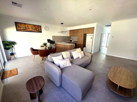 Spacious, light-filled living area with comfortable seating, TV & WIFI