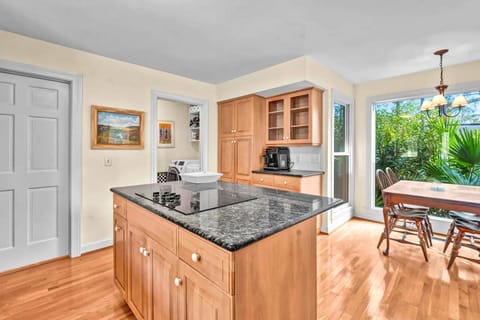 Prepare your favorite meals in this bright, fully-equipped kitchen with granite countertops, modern appliances, and garden views.
