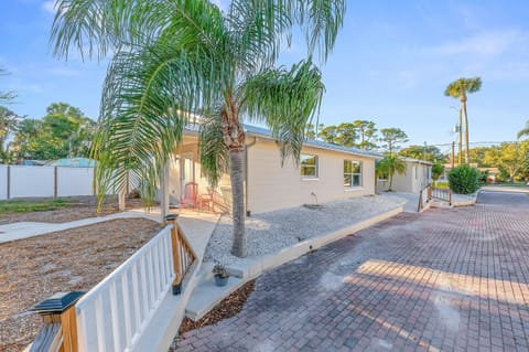 Beautiful beach stay home with a palm-lined driveway, private entry, and inviting outdoor seating. Enjoy tropical surroundings and easy access for a relaxing coastal getaway near the beach.