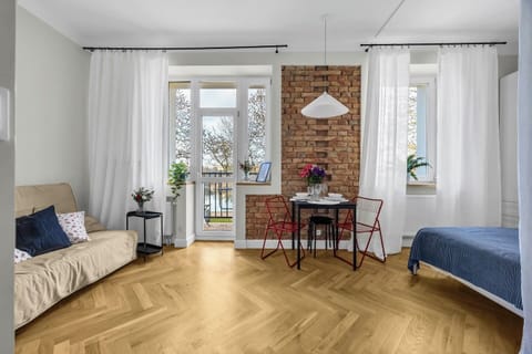 Bright Studio Living & Sleeping Area with Dining Space and Balcony Access | Book Now with RENTUJEMY.COM