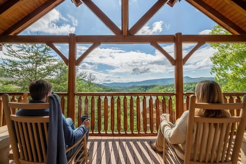 Your view from The Overlook — Smoky Mountain ridgelines, fresh mountain air, and a rocking chair with your name on it. This is what you came for.