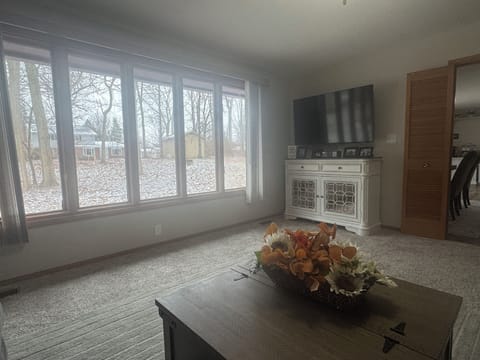 Living room with view of shady backyard