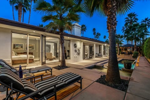 Palm-lined backyard with pool, spa, and twilight desert vibes