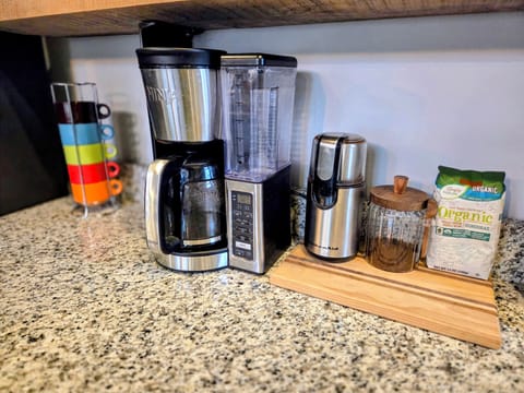 We have a drip coffee maker, coffee, and a grinder here for you