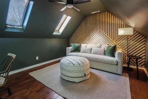 A quiet nook to work, read, or recharge — this flexible bonus room features a pull-out queen sofa and stylish design under skylit ceilings.