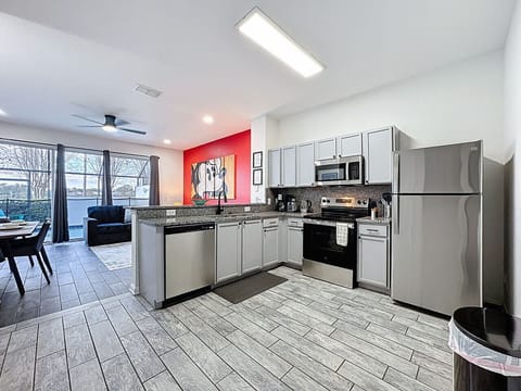 Modern Open-Concept Kitchen & Living Area — Fully equipped kitchen with appliances