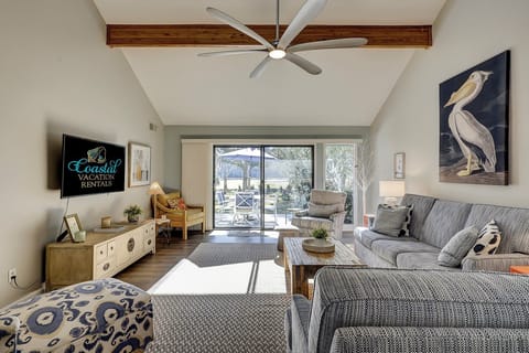 Living area with flatscreen tv and access to patio.