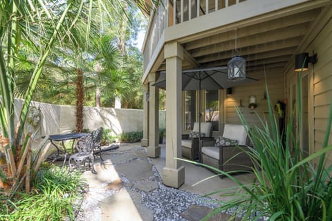 Private patio with a small table and 2 chairs with an umbrella.