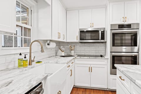 Contemporary kitchen with stainless steel ovens and ample counter space.