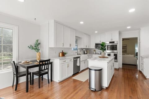 Modern kitchen featuring a large island and stainless steel appliances.