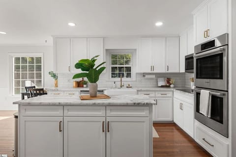 Bright open kitchen featuring a large prep island and modern appliances.