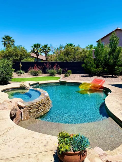 Resort style backyard with private pebbletec pool and spa with waterfall 