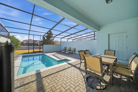Welcome to this sunlit oasis with a private pool and protective screen. Unwind on the cozy lounge chairs or savor a meal at the outdoor dining set, perfect for enjoying the warmth and peace of your stay.