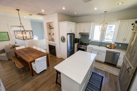 Your open-concept kitchen and dining space blends modern convenience with cozy charm, featuring sleek appliances and a warm fireplace for memorable meals.