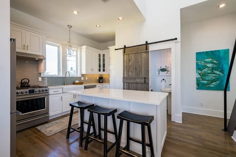 Step into your gourmet kitchen where white quartz counters invite morning coffee and the island becomes your gathering spot.
