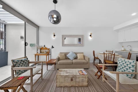The welcoming lounge invites you to stretch out on generous seating, enjoy the TV, browse books, and settle into a calm, thoughtfully styled inner-city retreat.