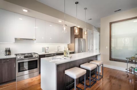 Chef's kitchen with granite waterfall countertop and all your cooking needs