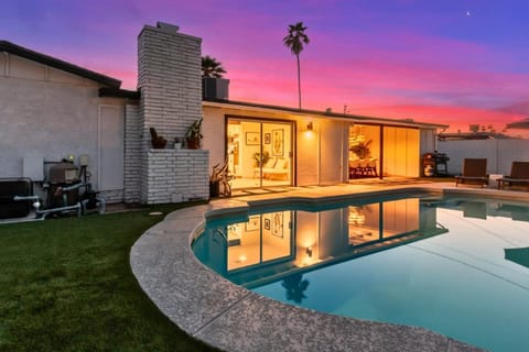 Twilight pool and backyard oasis with lounge seating