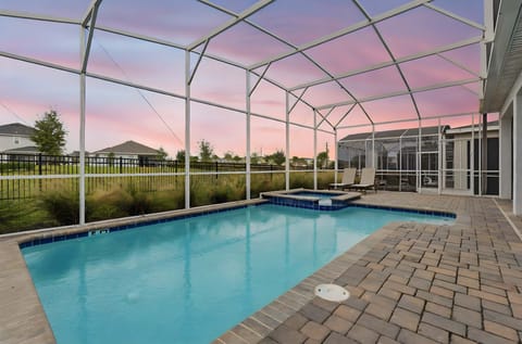 Enjoy a private screened pool area with lounge chairs at sunset.